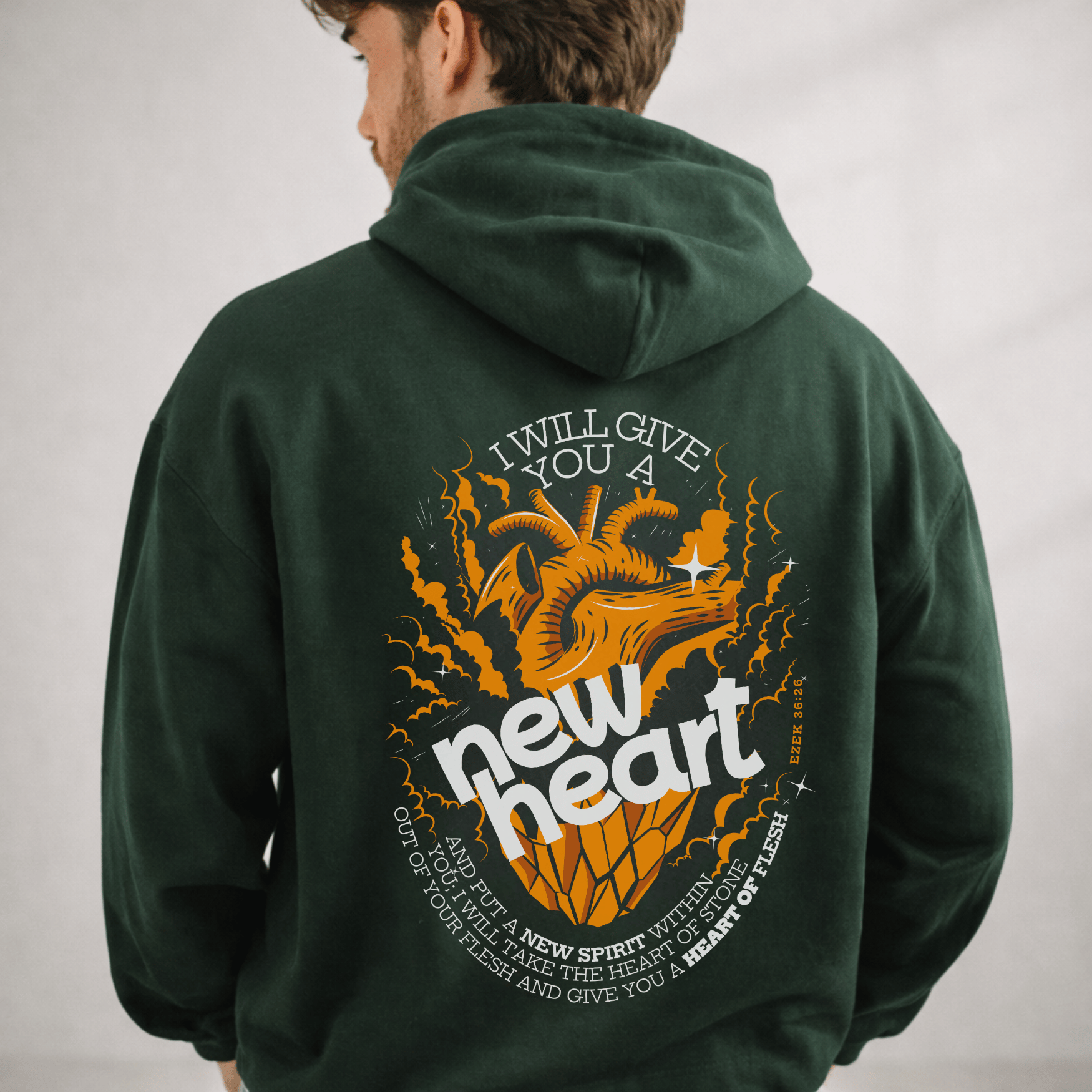 Person wearing a green hoodie with a dragon graphic and text on the back, on a plain background