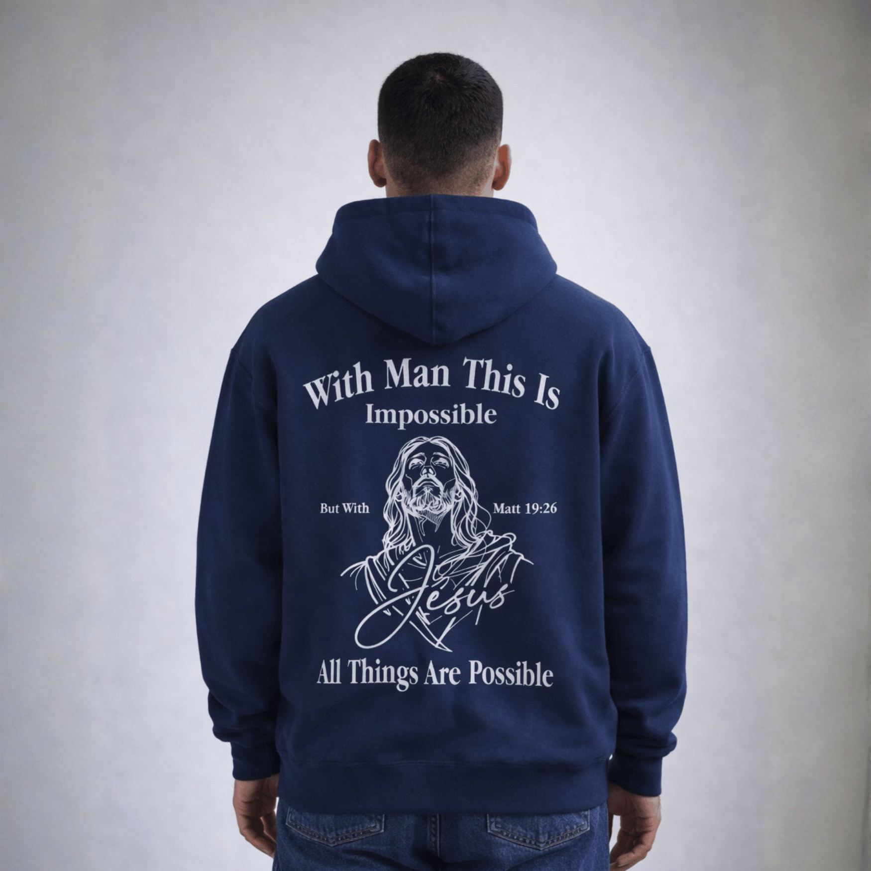 Person wearing a navy blue hoodie with text and a graphic on the back, standing against a plain background.