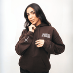 Person wearing a brown hoodie with text on a white background